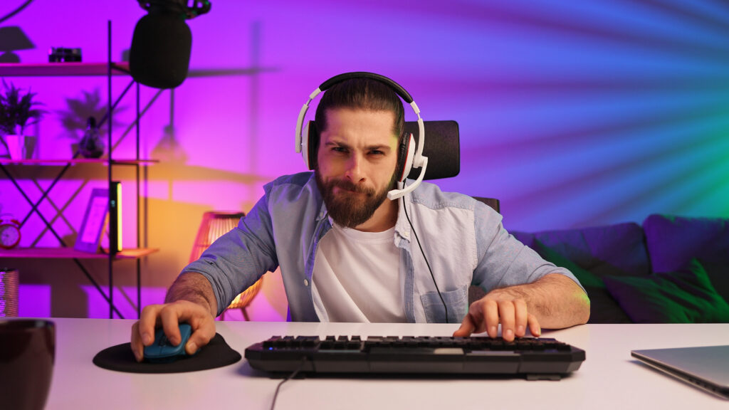 Gamer bearded guy, in a gaming headset, wins a video game.