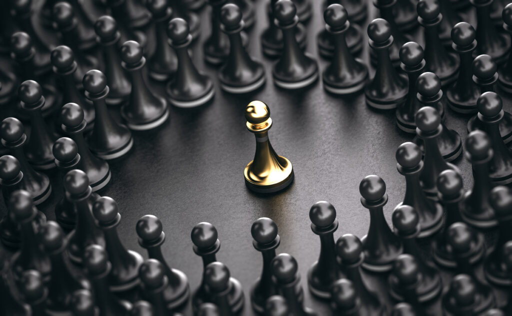 3D illustration of black pawns around a golden one standing out from the crowd.