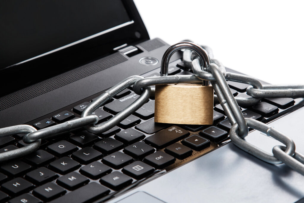 Padlock and chain on a laptop keyboard.