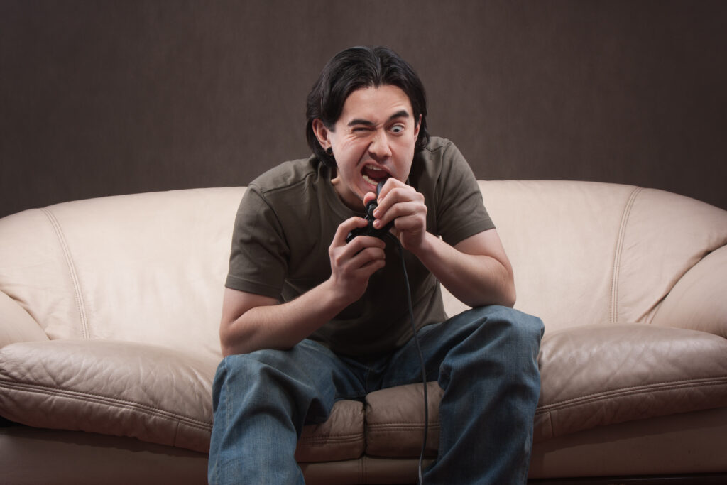 Gamer biting a game controller in a goofy and funny way.