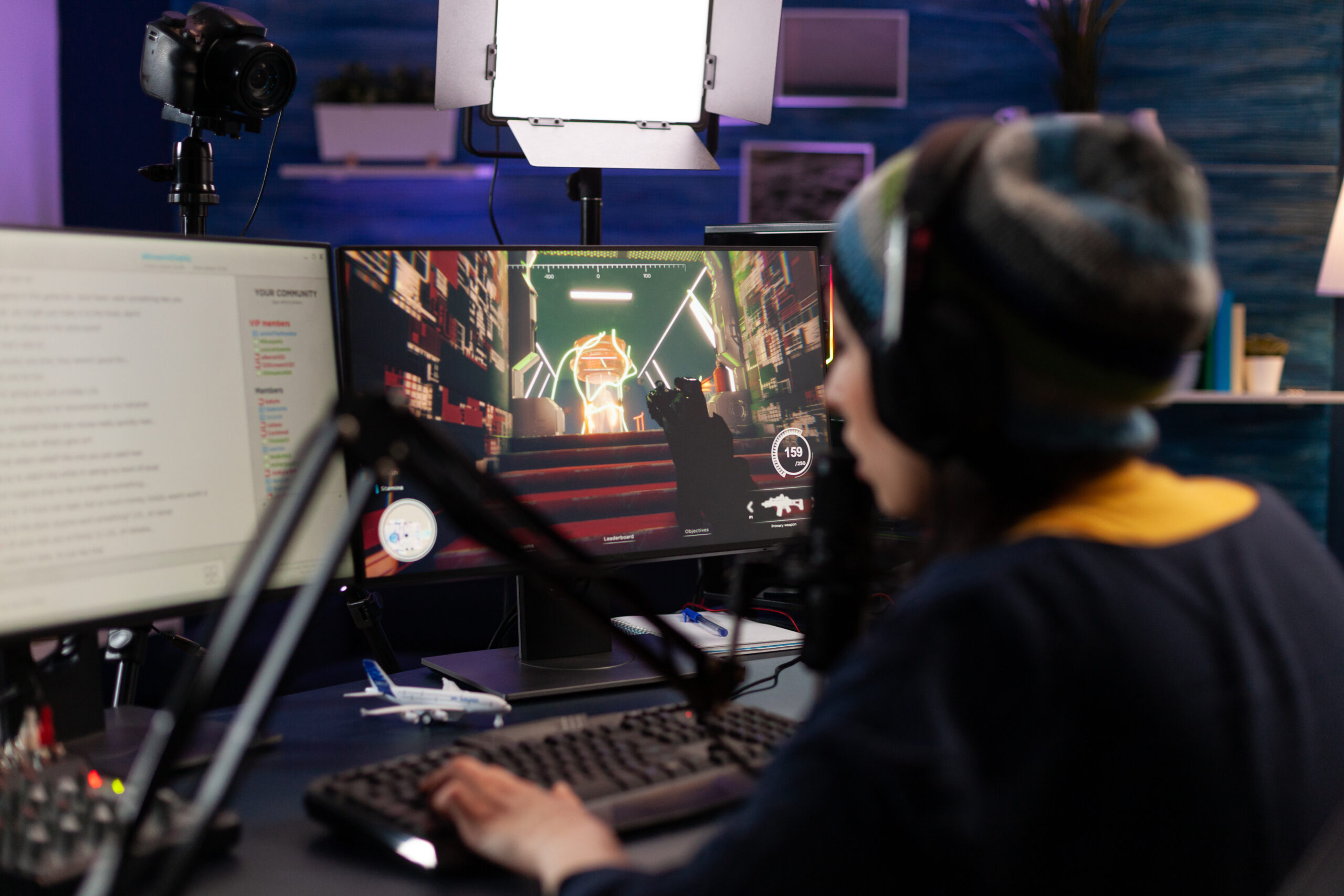 Woman live streaming video games on monitor with chat.