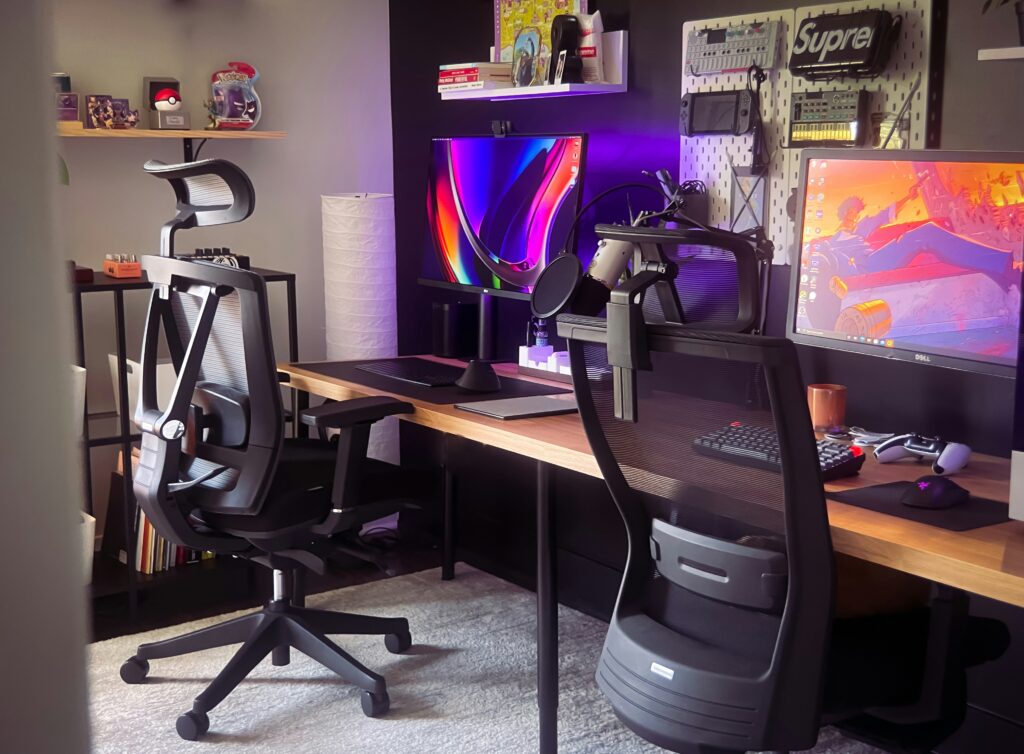 Gaming room with a long table with two office looking chairs.